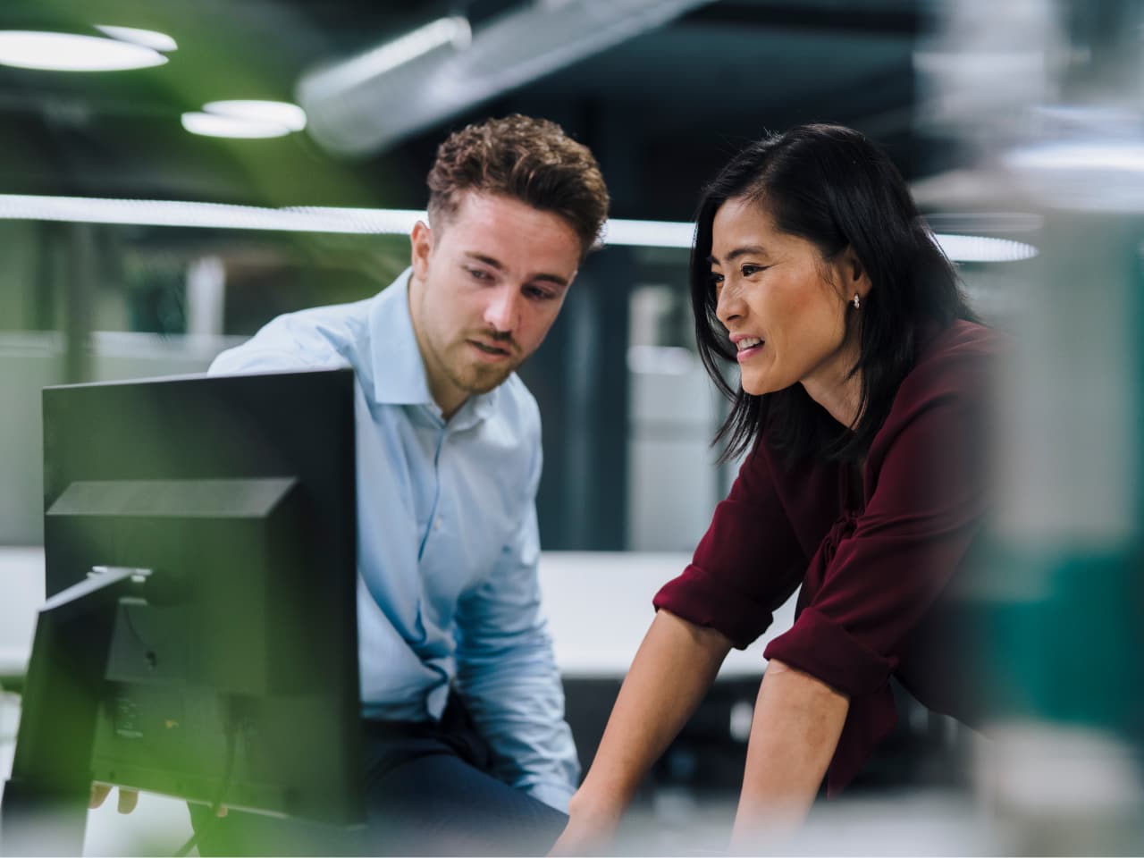 Man and woman looking at monitor
